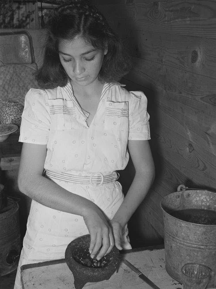 Mexican Girl Grinding Peppers, Robstown, Texas By Russell Lee