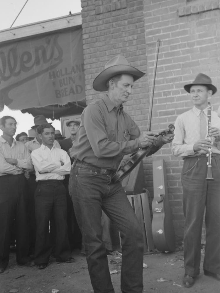 Member Of Orchestra Which Plays Outside Grocery Store On Saturday Afternoon Tuning His Violin, Phoenix