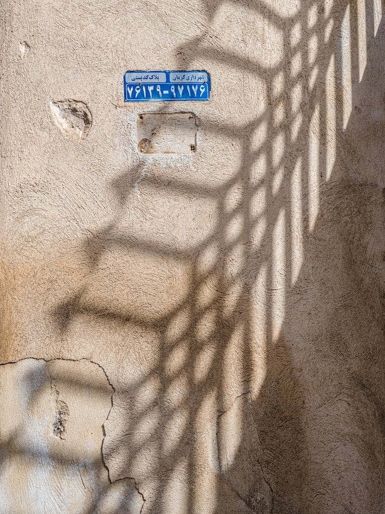 Shadow And A Street Sign