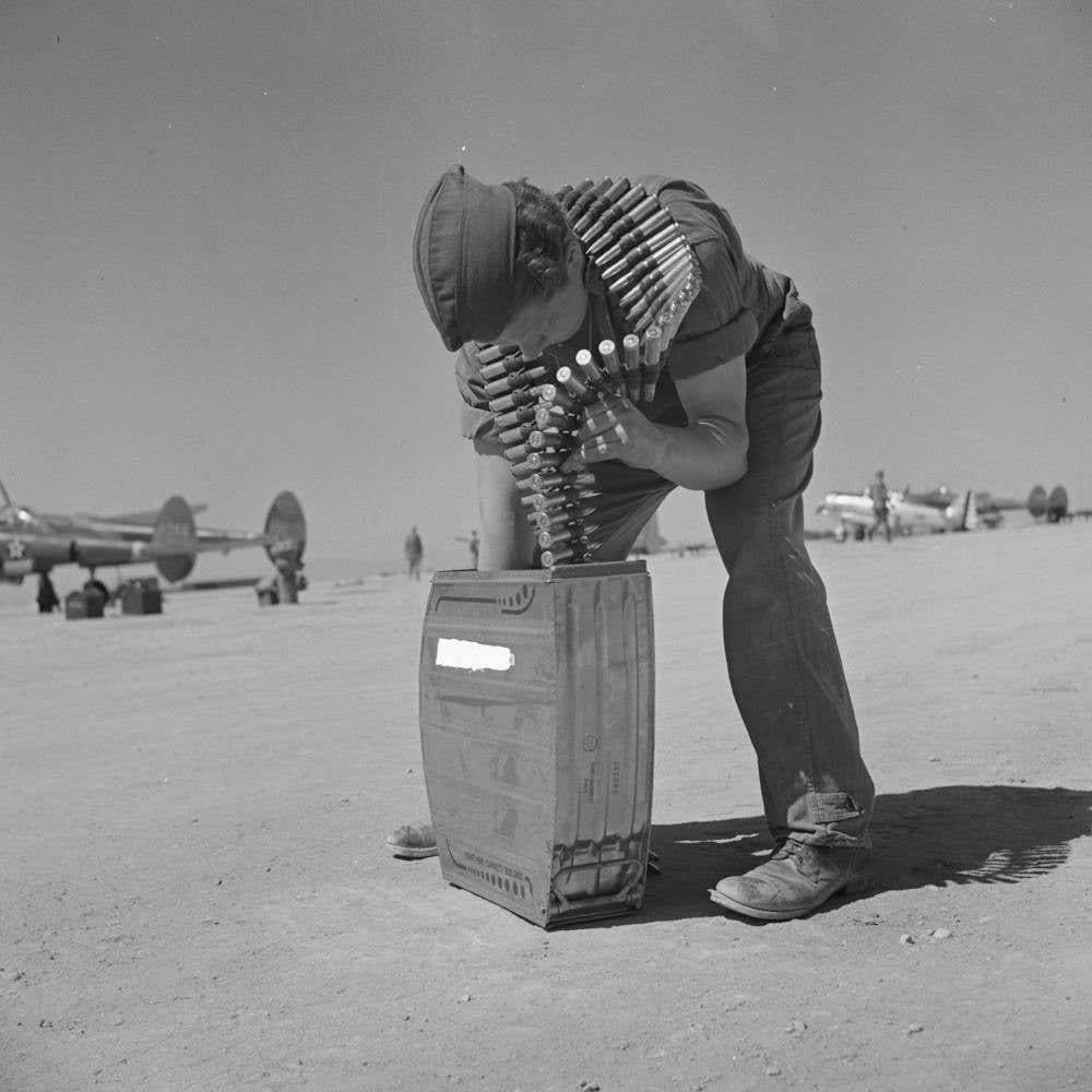 Armorer Placing Fifty Caliber Machine Gun Bullets In Magazine, Lake Muroc, California By Russell Lee