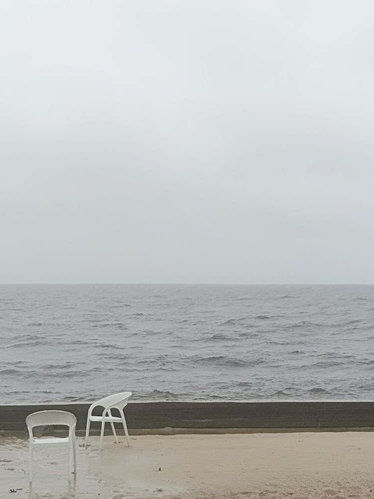 White Chairs art photo photography beige gray rainy day sea water lonelines serene contemporary