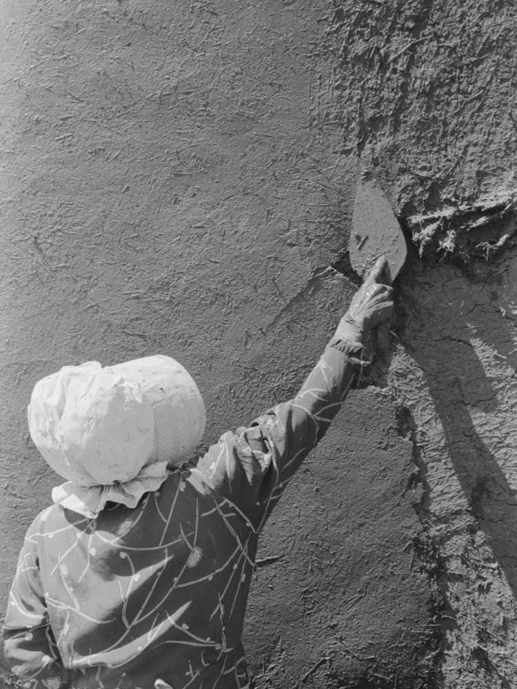 Spanish American Woman Plastering Adobe House, Chamisal, New Mexico By Russell Lee 2
