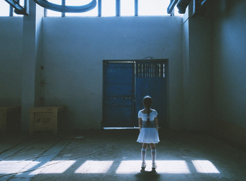 A White Dress Stands In An Empty Room