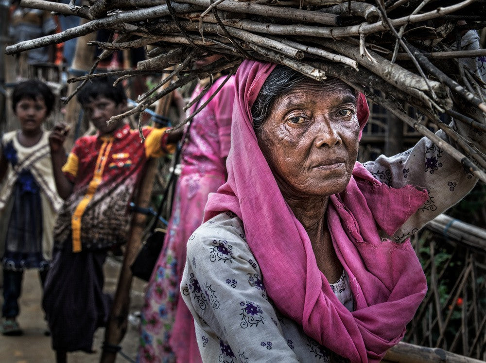 Rohingya refugee woman carrying some wood - Bangladesh