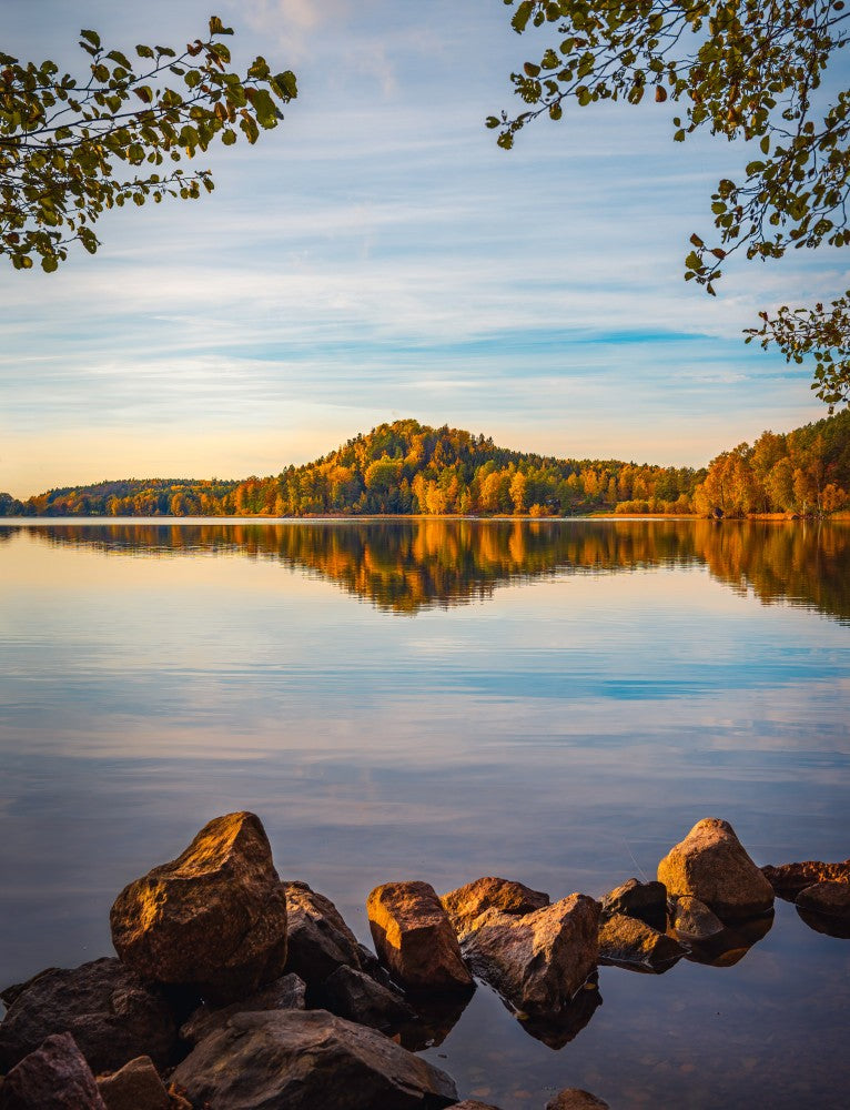 Autumn lake with a small mountain in the background