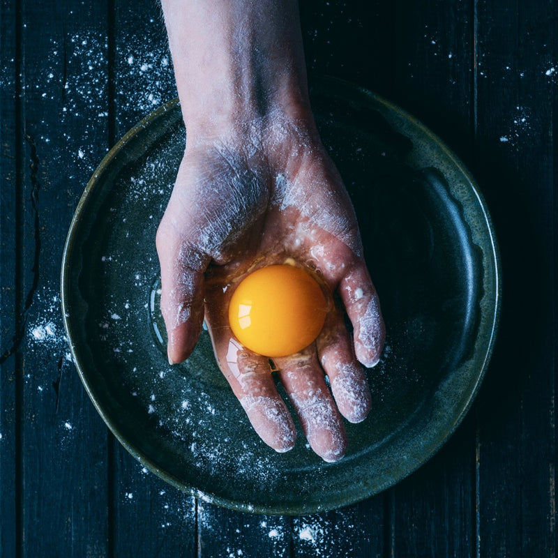 Vibrant Egg Yolk Against A Dark Plate