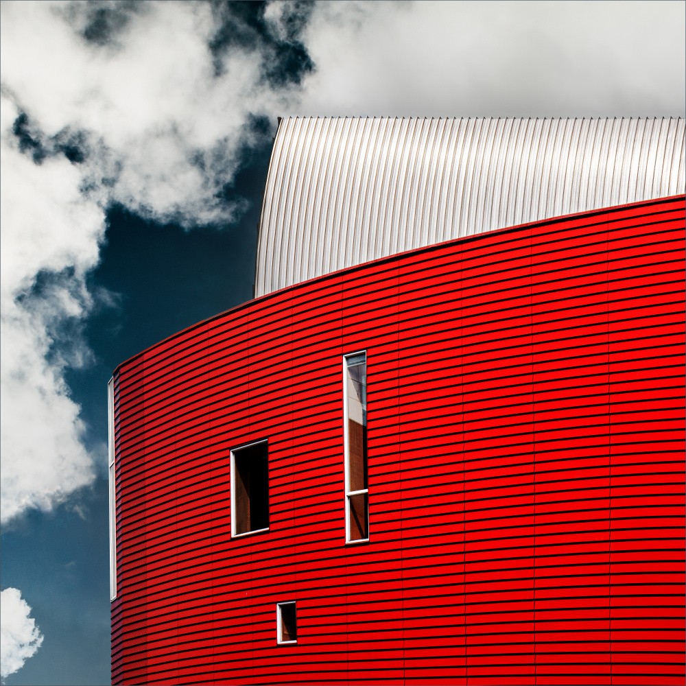 Three tiny windows in red wall