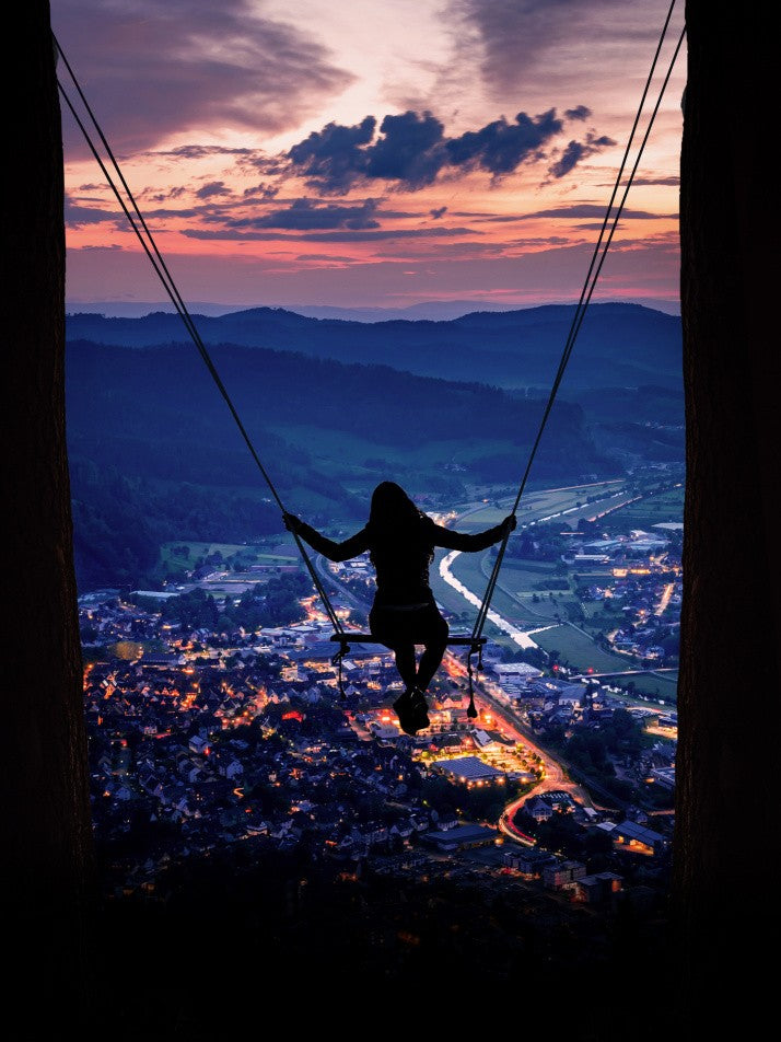 Silhouette Of A Woman On A Swing