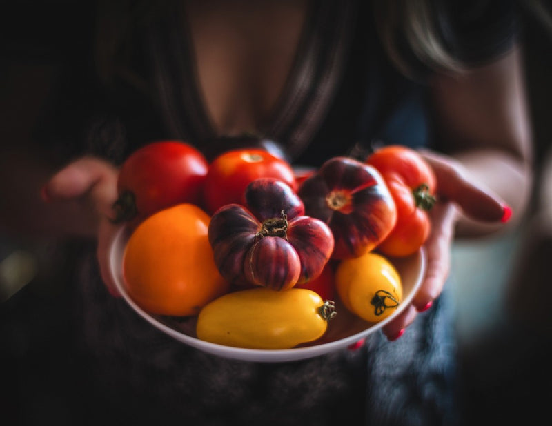 A Bowl Of Fresh Heirloom Tomatoes And Peppers