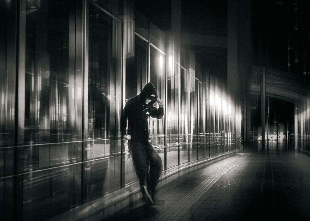 STANDING QUIETLY IN A GLASS-ENCLOSED CORRIDOR