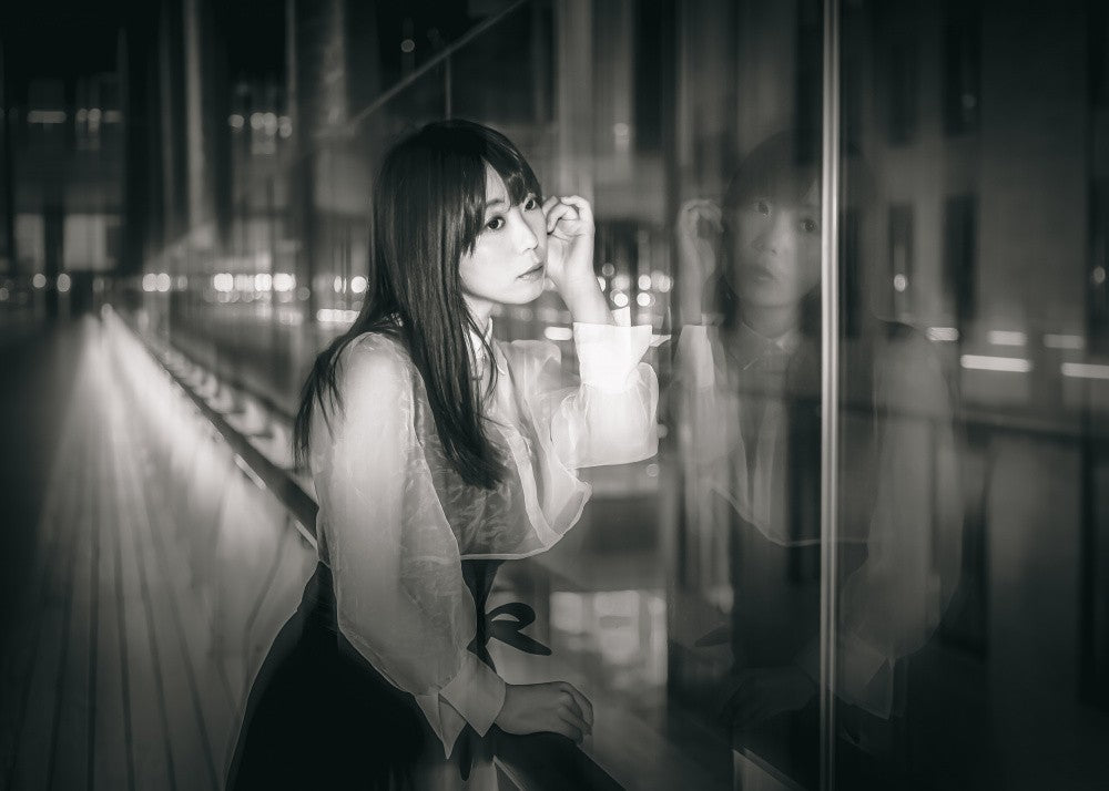 THE GLASS-COVERED PASSAGE AND HER REFLECTION