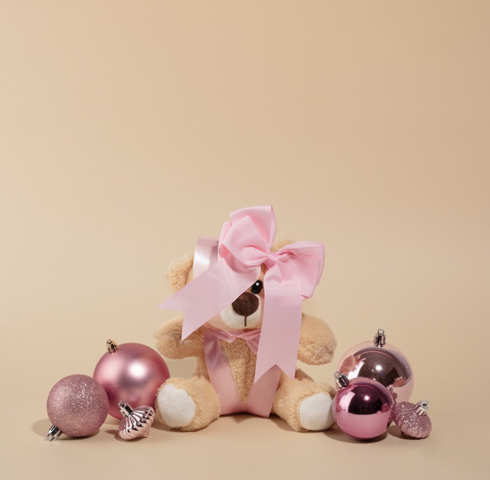 Teddy Bear Surrounded by Pink Ornaments