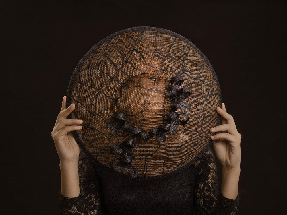 shyly hidden behind a hat