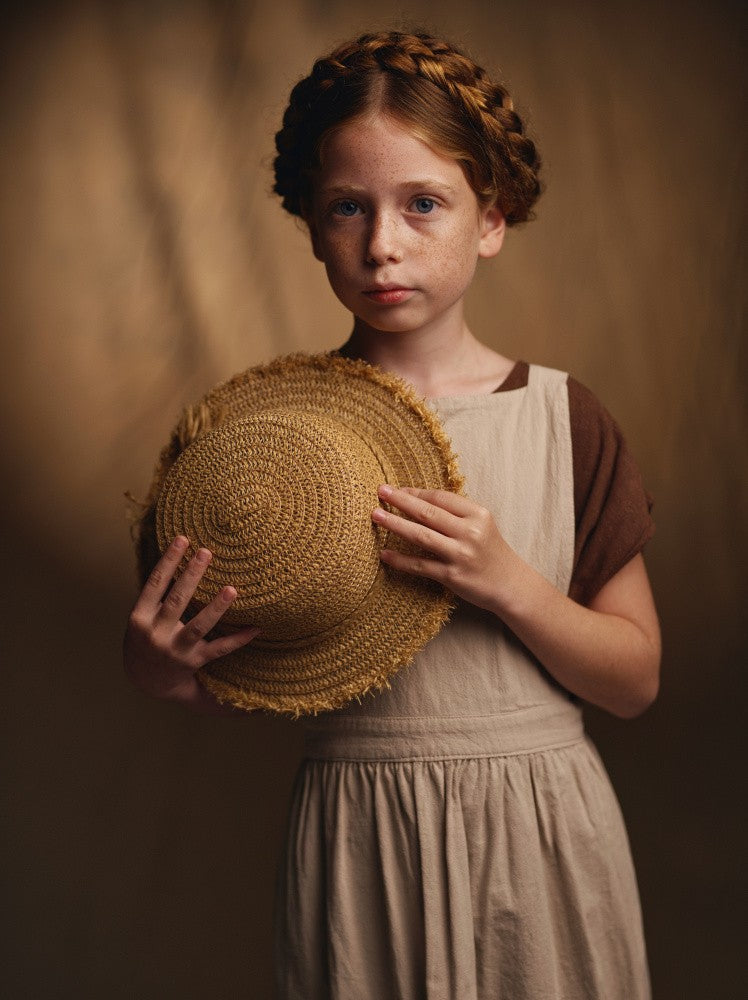 Holding her hat