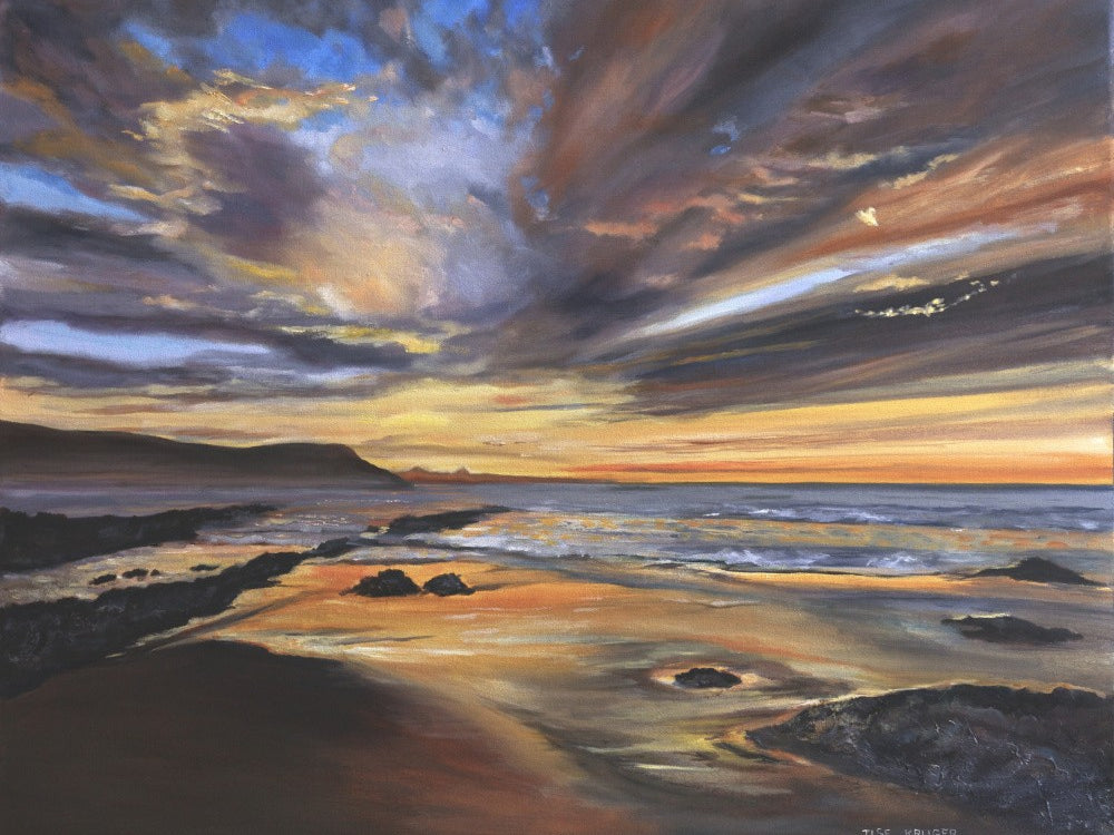 Serene Sunset over a Rocky Beach