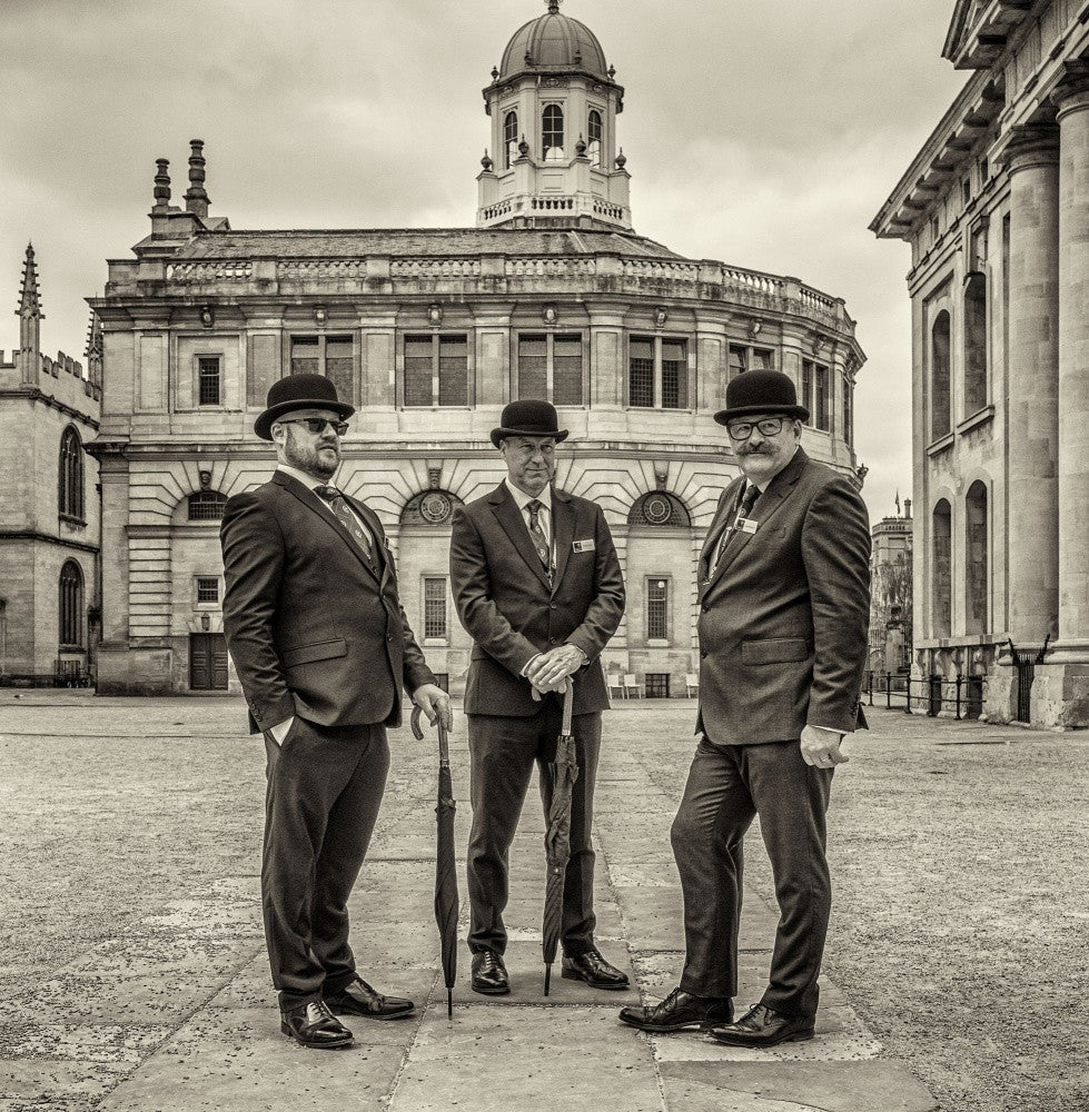 Three gentelmen in bowler hats.