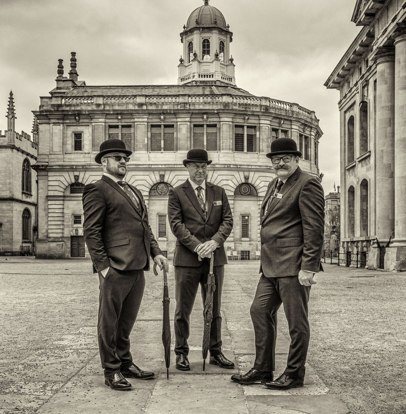 Three gentelmen in bowler hats.