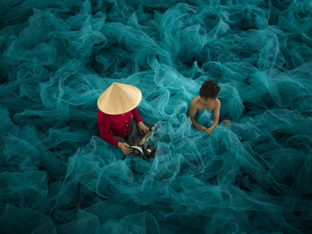a mother and child on a green net