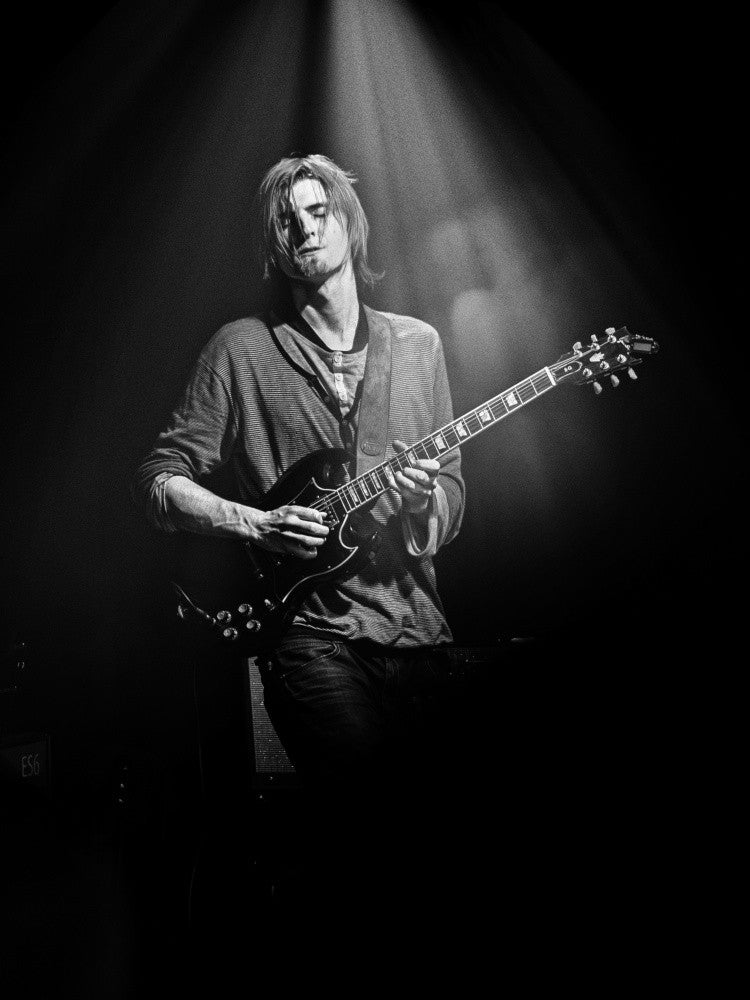 Playing guitar under the spotlight