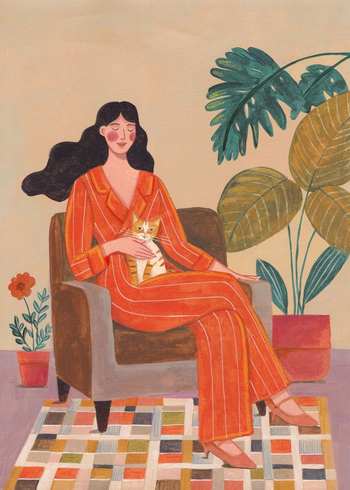 Woman with cat in living room with warm earth tones