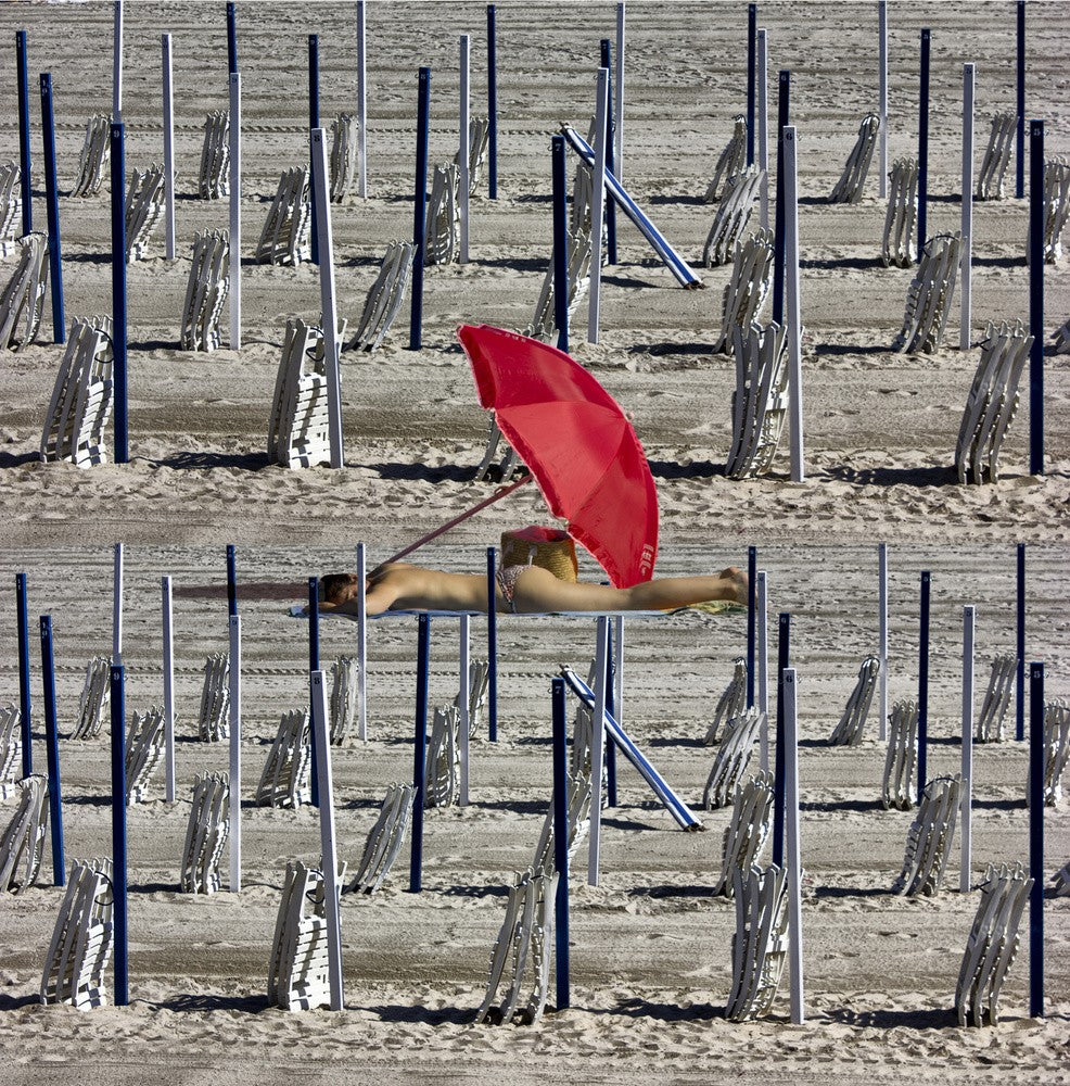 Composition of poles and chairs with red umbrella