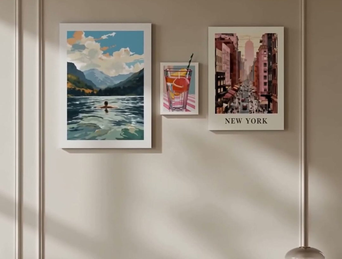 Gallery wall of five framed prints in a sunlit room