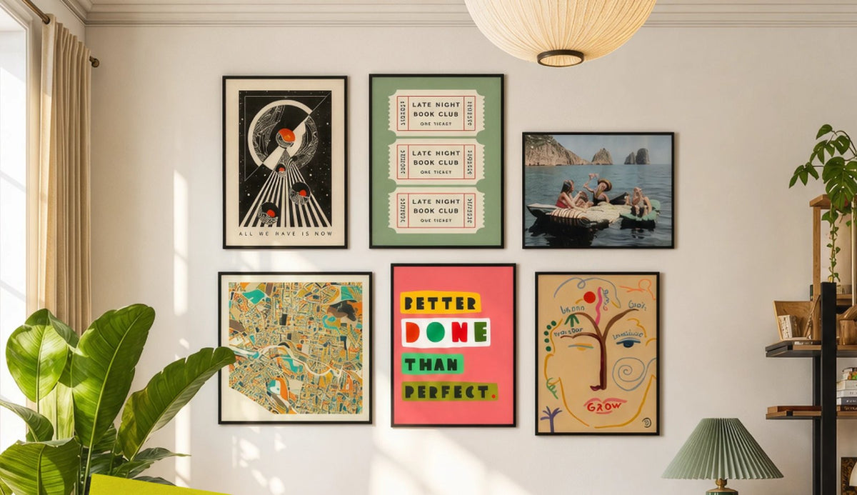 Gallery wall of six framed prints above a pale sofa in a sunlit living room