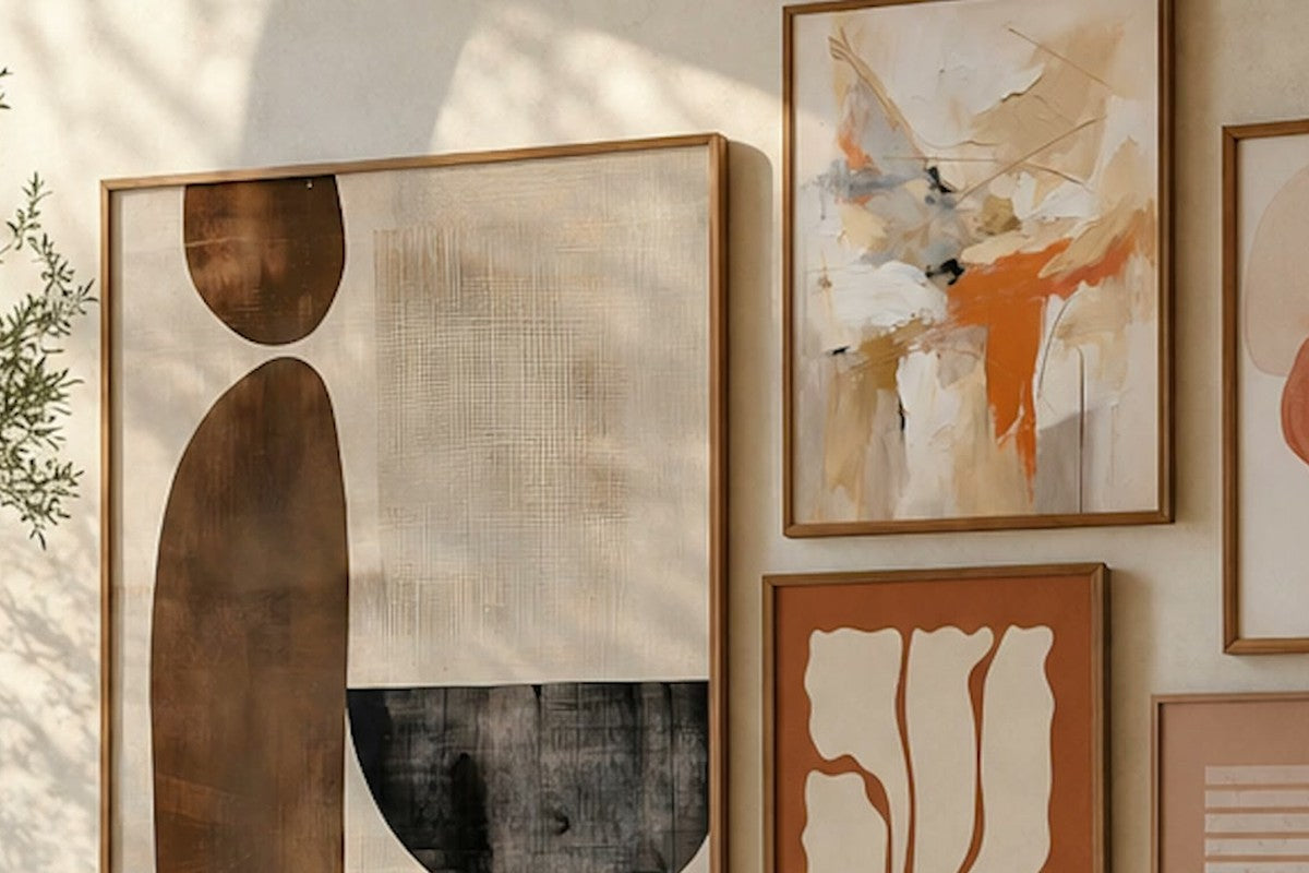 Living room wall of warm neutral abstract prints above a sofa