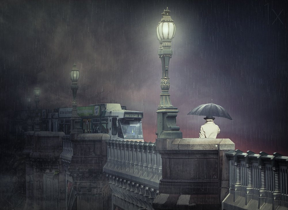 Man on Rainy Bridge