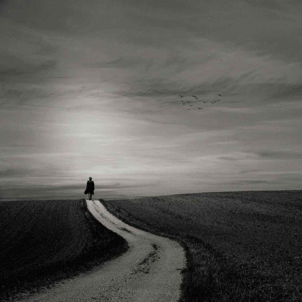 Lone Figure Winding Road