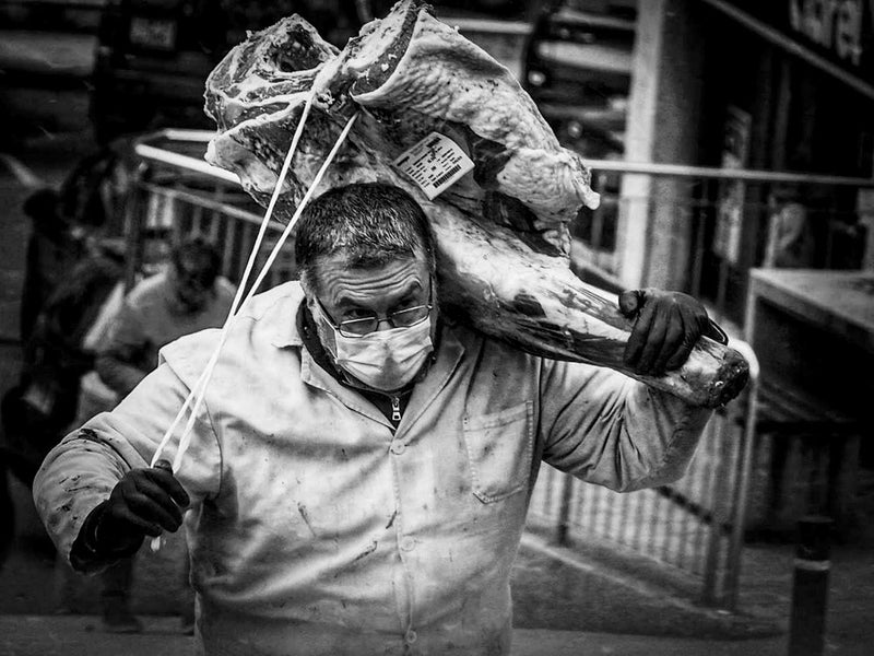 Butcher Carrying Meat