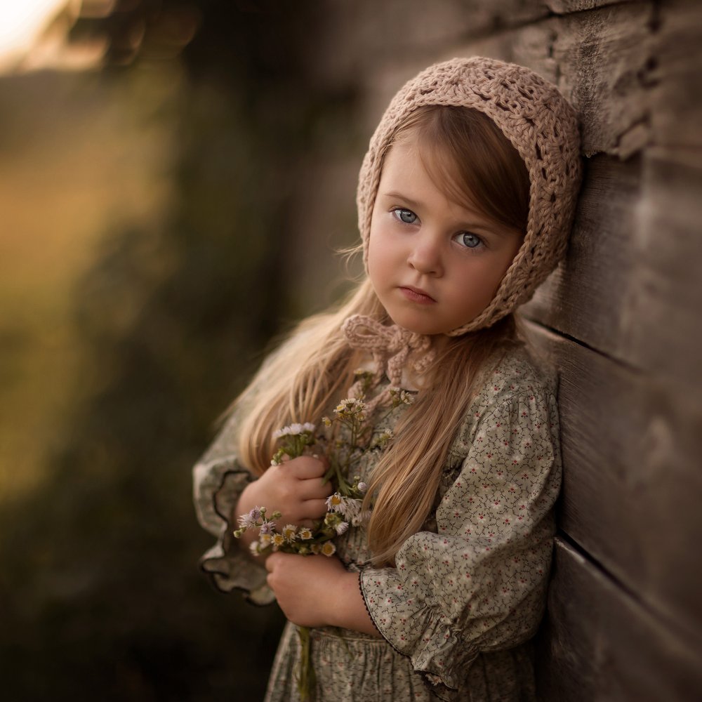 Pensive Girl Holding Flowers