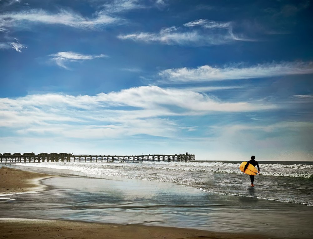 Surfer Walks Ocean