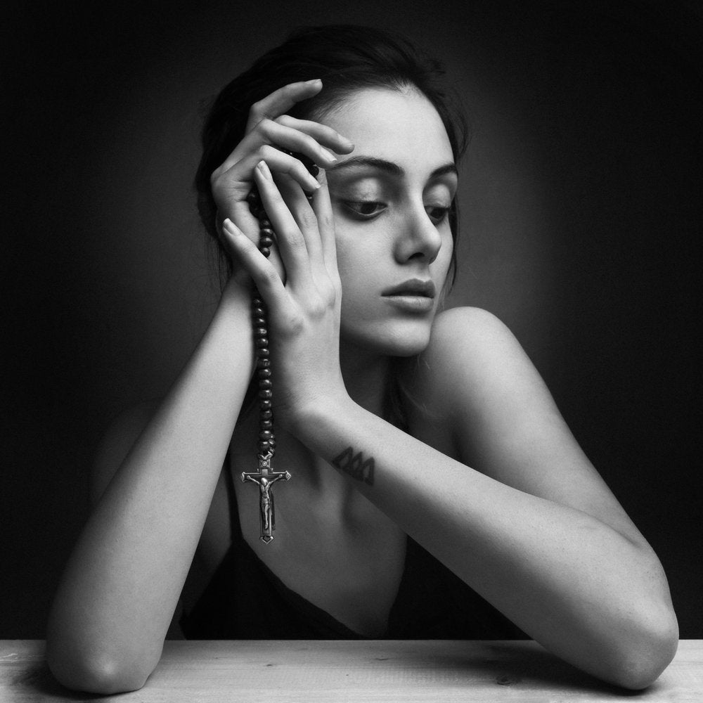 Pensive Woman With Rosary