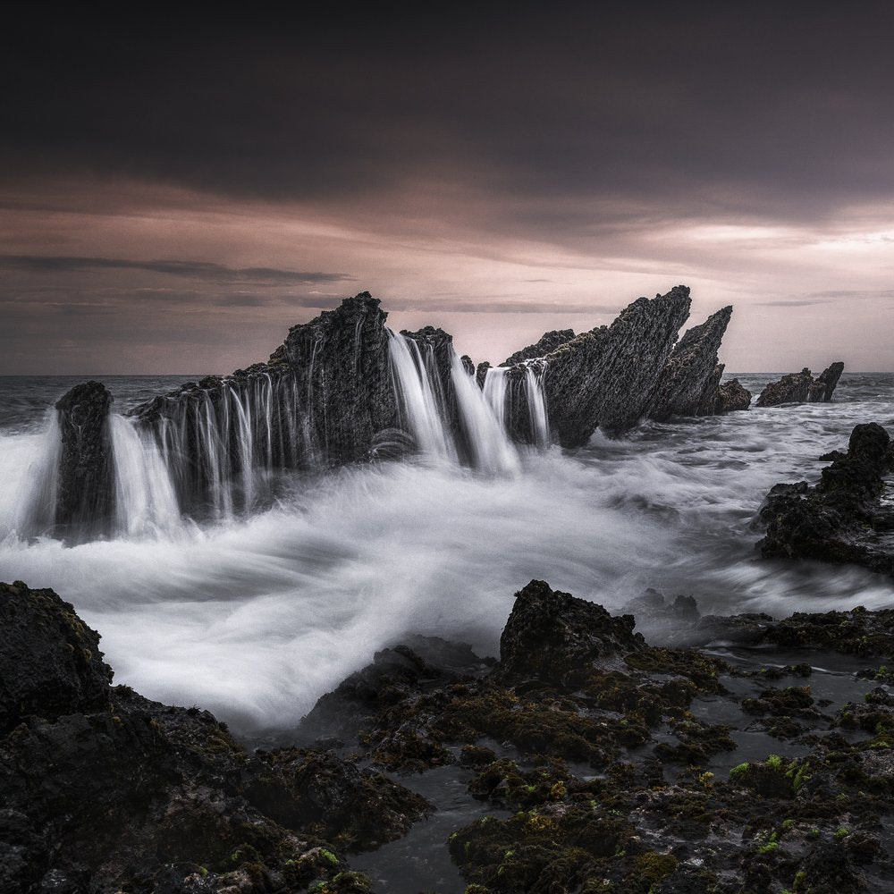 Dark Coastal Waterfall