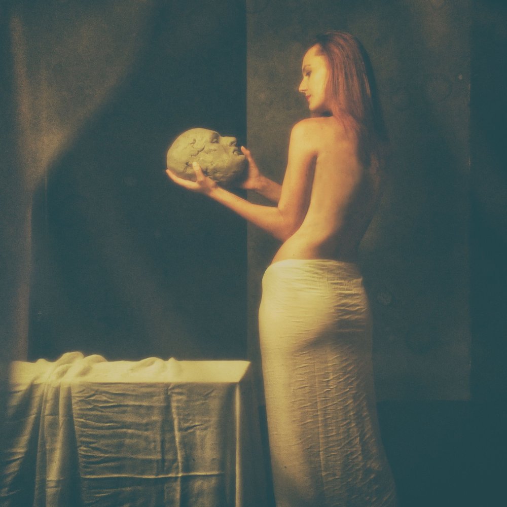 Woman Holding Clay Head