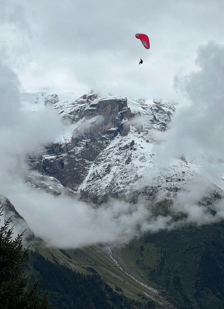Red Paraglider Mountain Flight