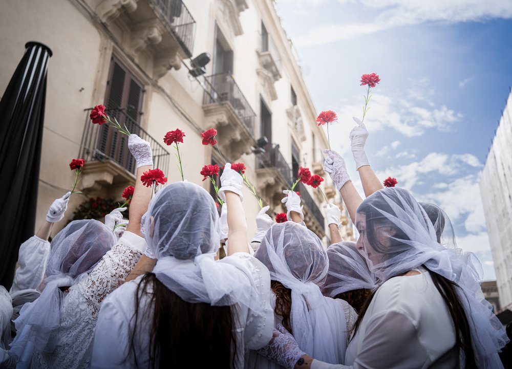 Women Holding Carnations