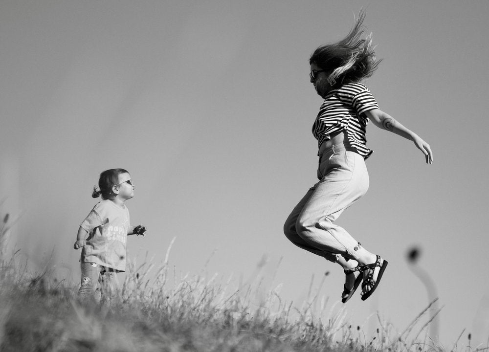 Playful Mother Daughter Jump