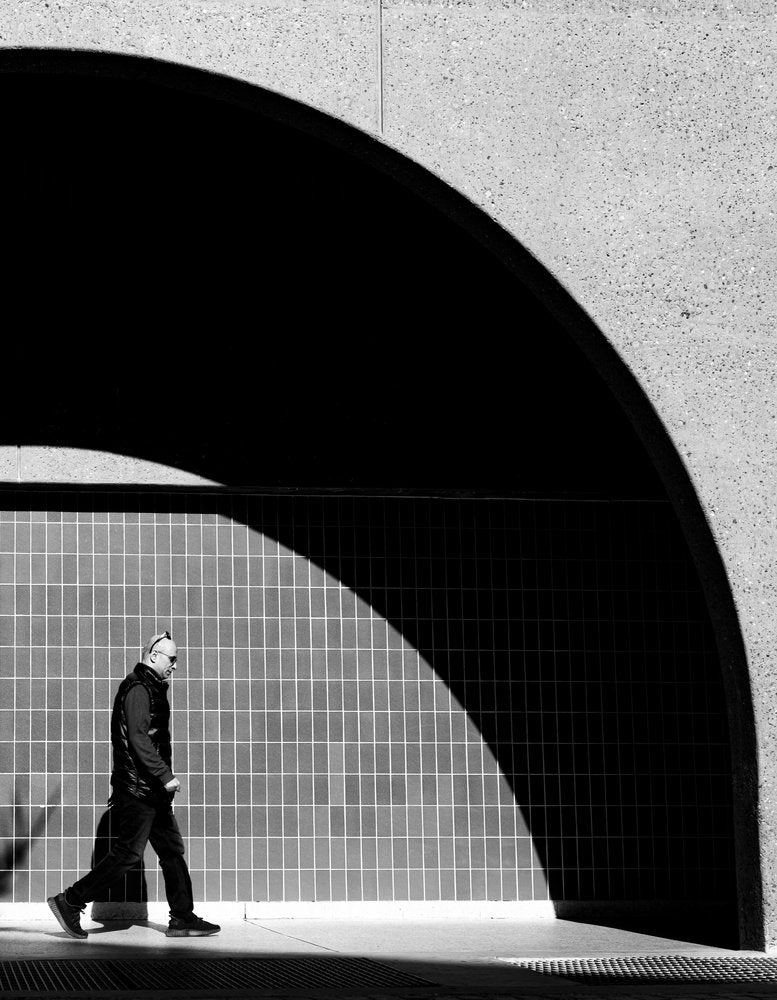 Man Walking In Shadow