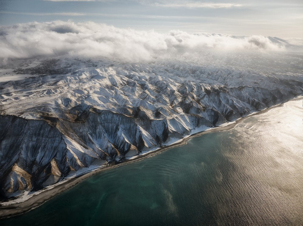 Sunlit Snowy Coastal Mountains