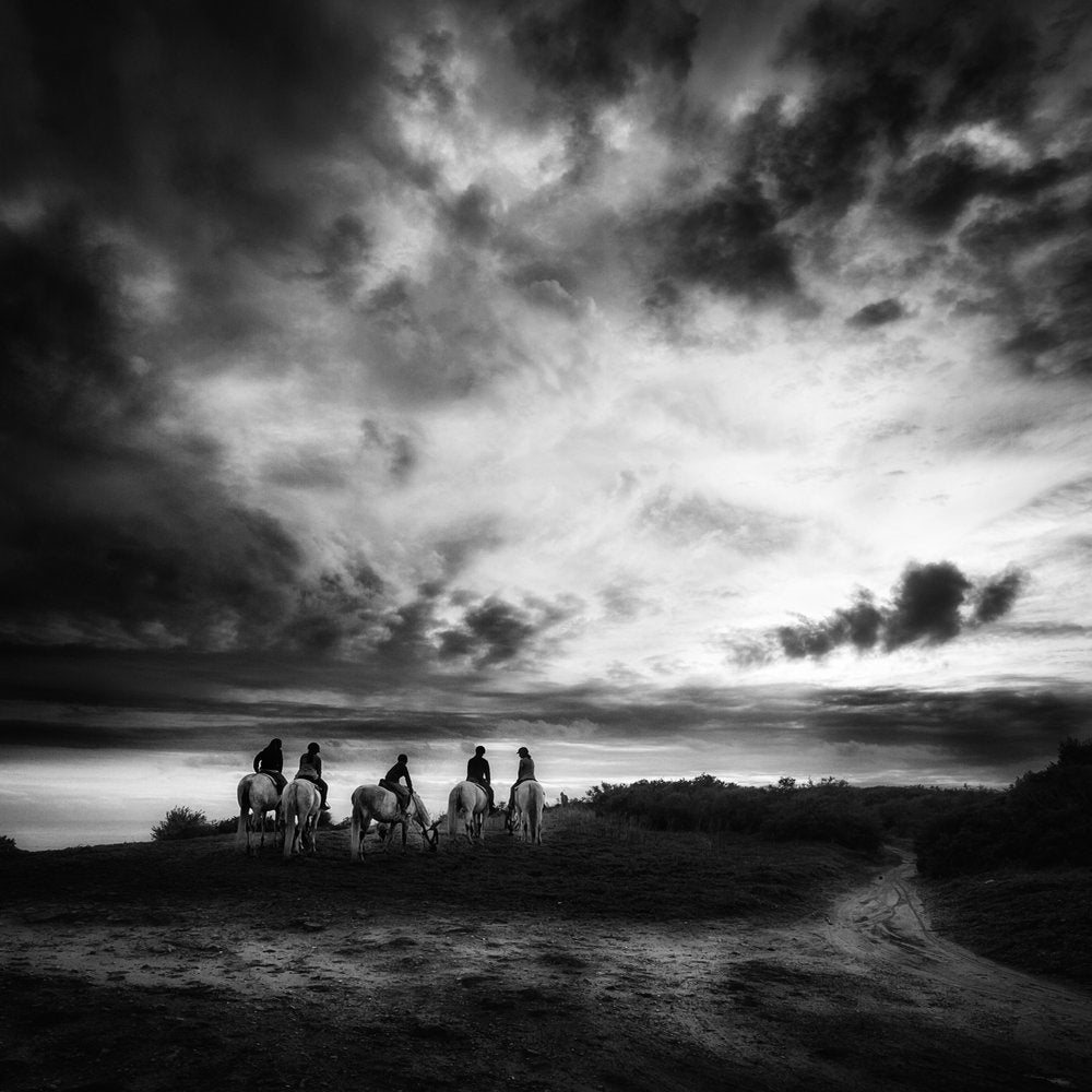 Riders Under Dramatic Sky