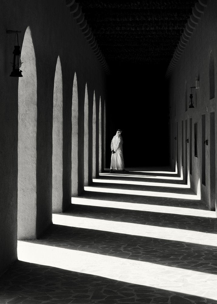 Solitary Figure Arched Hallway