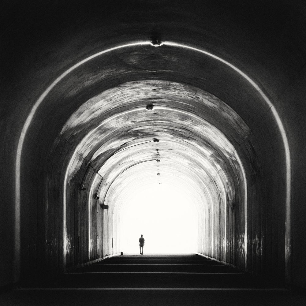 Man Walking Towards Light