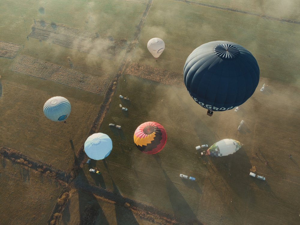 Balloons Above Misty Fields