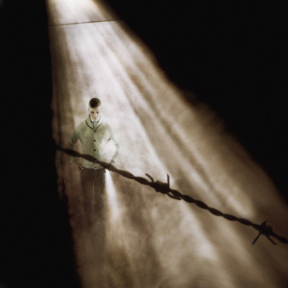 Man Behind Barbed Wire