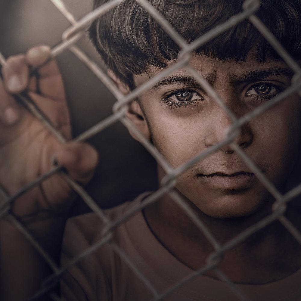 Young Boy Through Fence