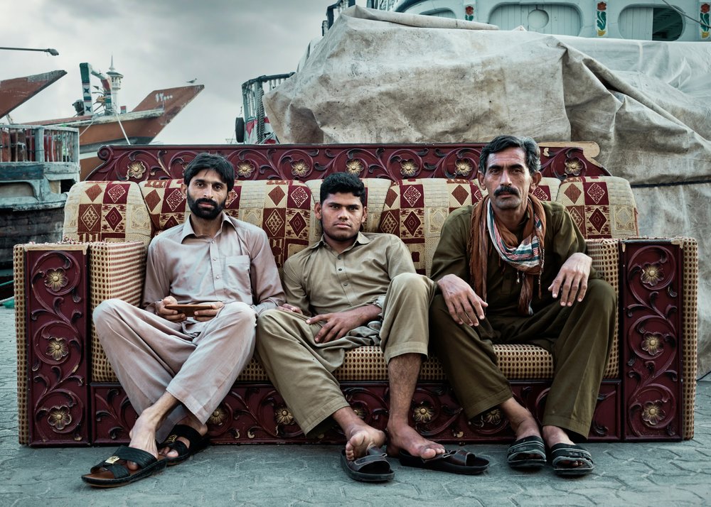 Three Men on an Ornate Sofa