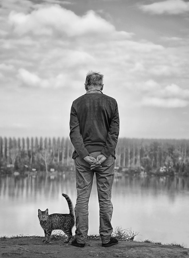Contemplative Man And Cat