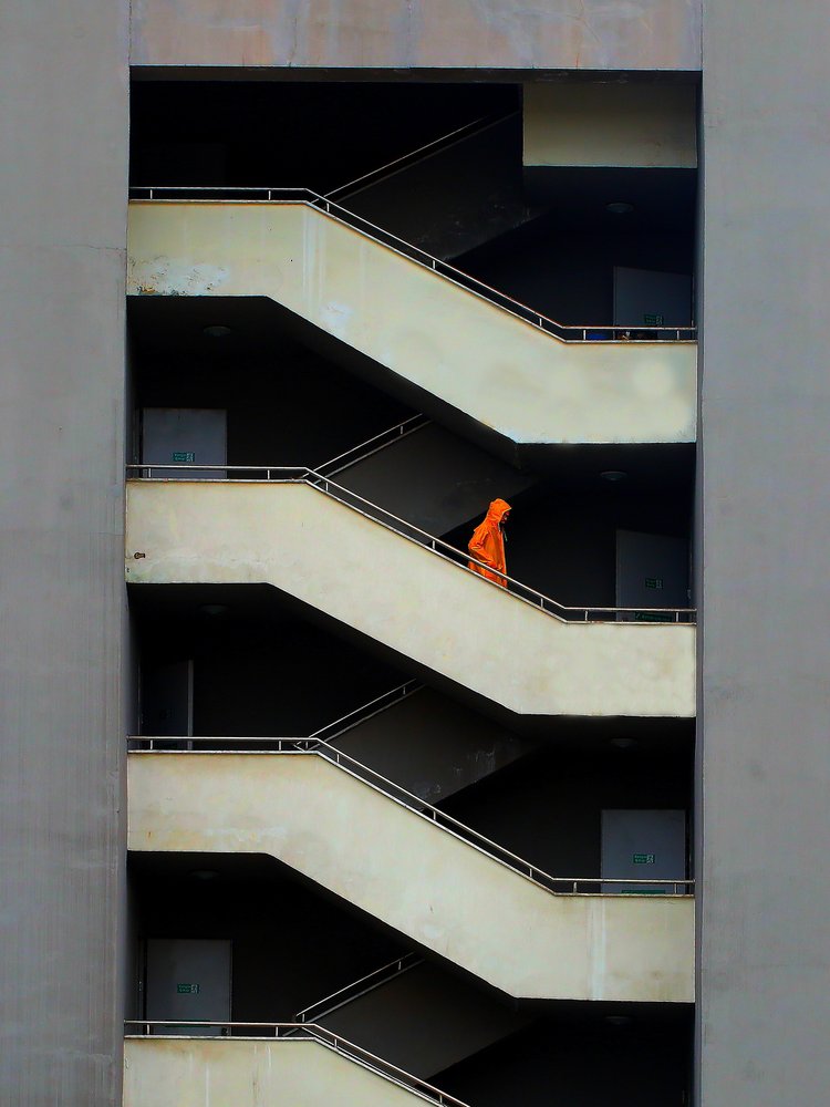 Orange Hooded Figure Stairs